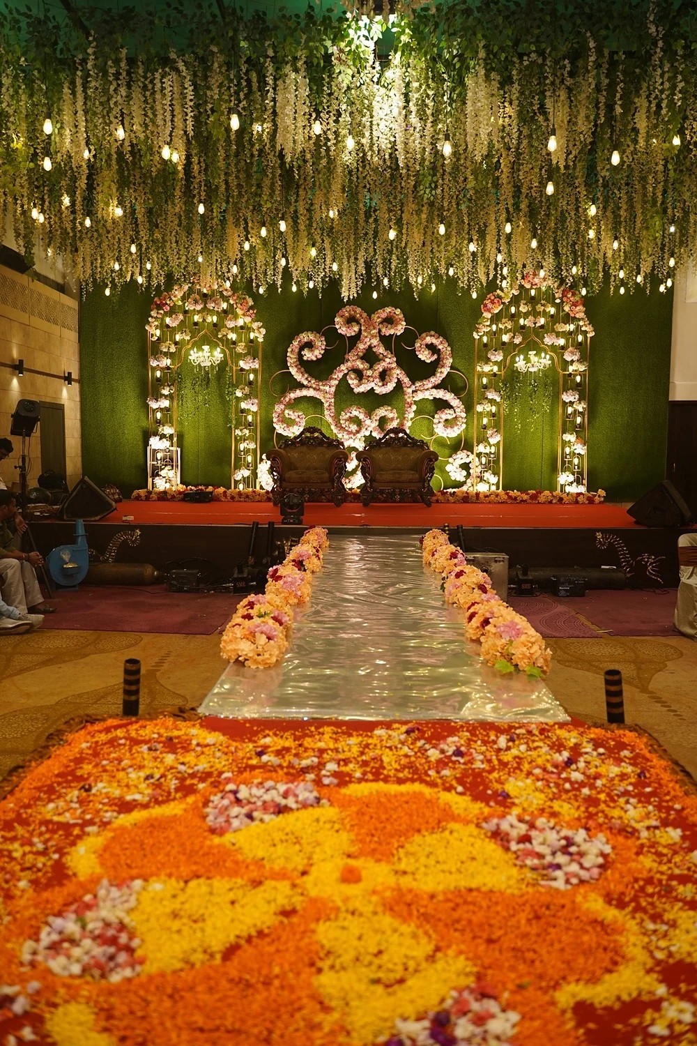 Floral rangoli aisle leading to the grand stage at Bika Banquets, Golaghata