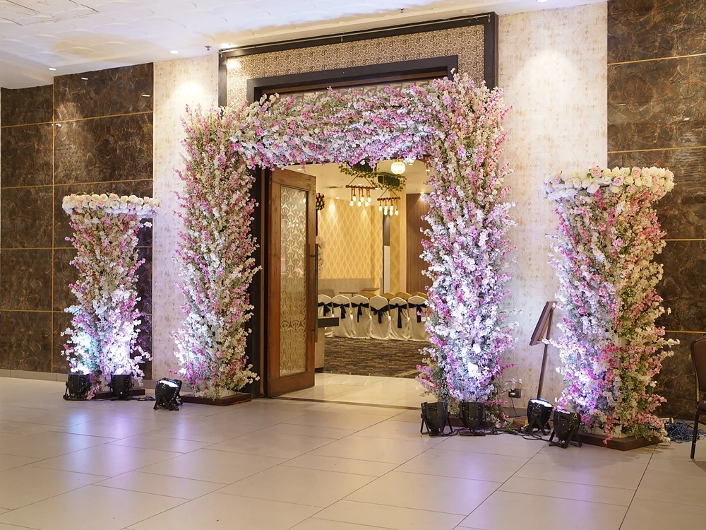 Pink & white floral arch doorway at Bika Rangoli, Howrah